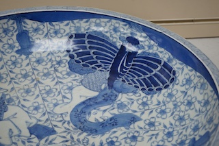 A large Japanese blue and white decorated charger, 47cm diameter. Condition - riveted and chips to rim